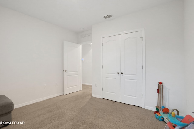 unfurnished bedroom featuring carpet floors and a closet