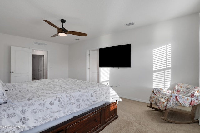 bedroom featuring light carpet and ceiling fan