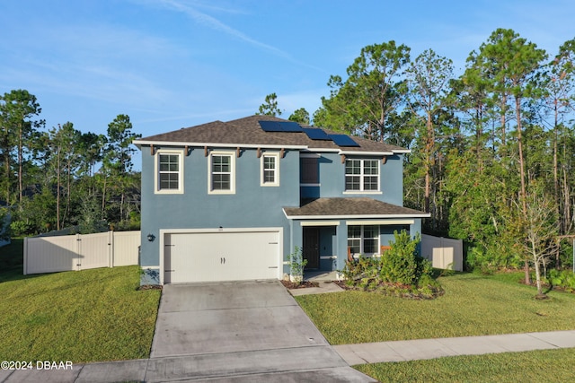 view of front facade with a front lawn, a garage, and solar panels