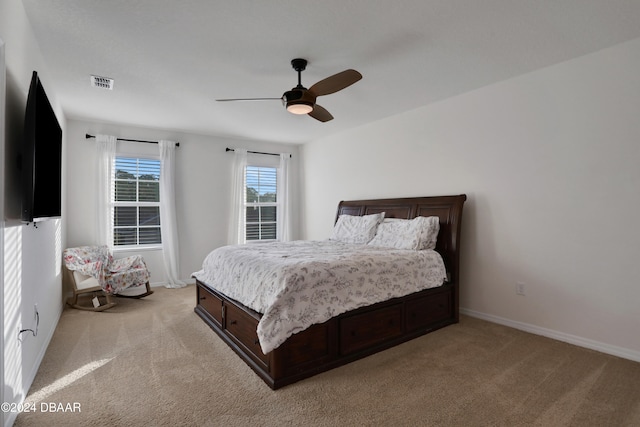 bedroom featuring ceiling fan and light carpet