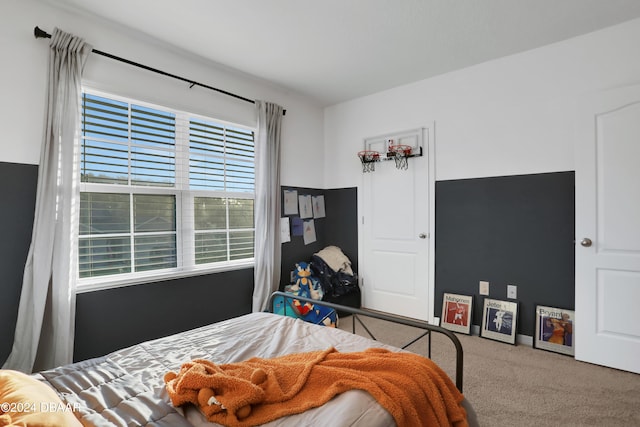 carpeted bedroom with multiple windows