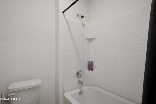 bathroom featuring toilet and  shower combination