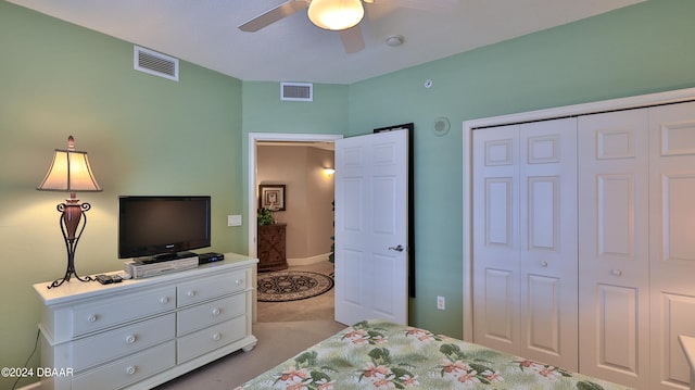 bedroom featuring a closet, light carpet, and ceiling fan