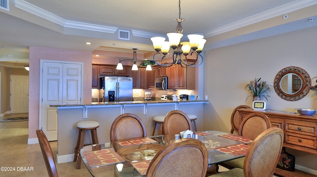 dining area with light tile patterned floors, an inviting chandelier, and crown molding