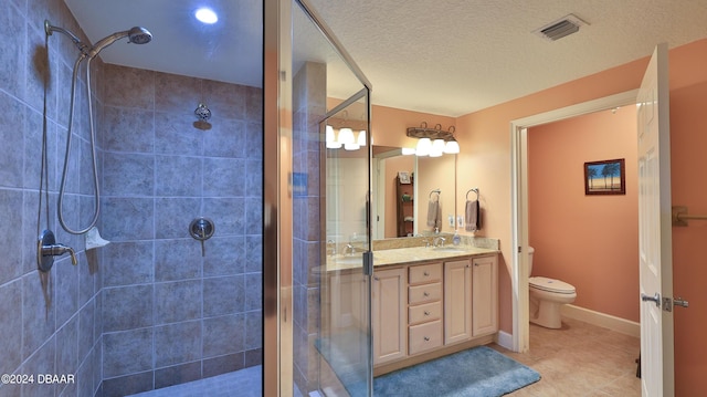 2403 S Atlantic Ave Unit 1210, Daytona Beach Shores, FL 32118 - full bath with a shower stall, tile patterned floors, toilet, double vanity, and a textured ceiling