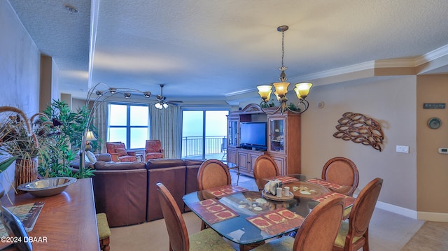 tiled dining room featuring a textured ceiling, crown molding, and ceiling fan with notable chandelier