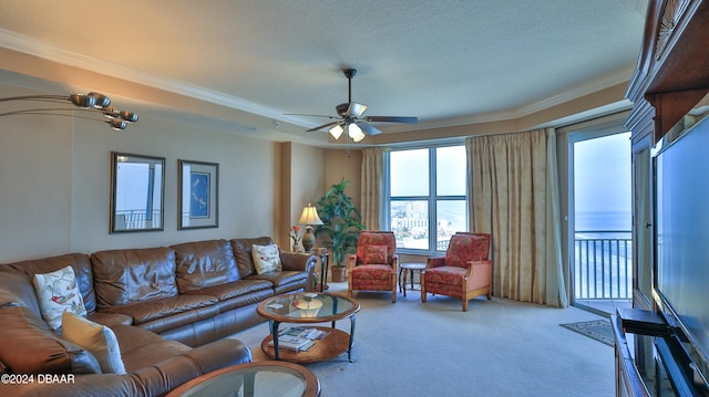 living room featuring a textured ceiling, carpet, ceiling fan, and crown molding