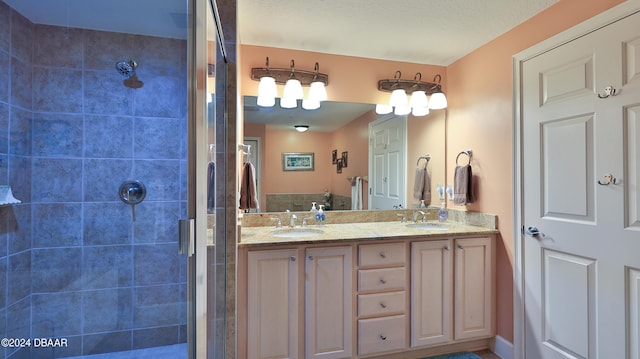 bathroom featuring vanity, a textured ceiling, and a shower with shower door