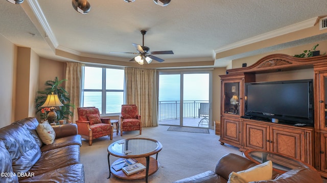 carpeted living room featuring a textured ceiling, ceiling fan, and crown molding