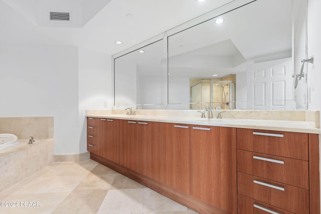 bathroom with tile patterned flooring, vanity, and plus walk in shower