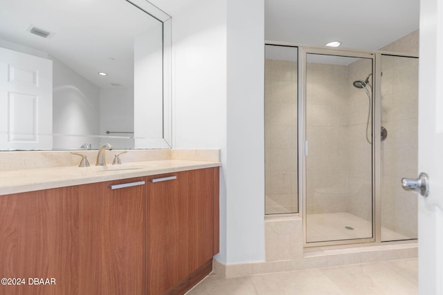 bathroom featuring vanity, an enclosed shower, and tile patterned floors