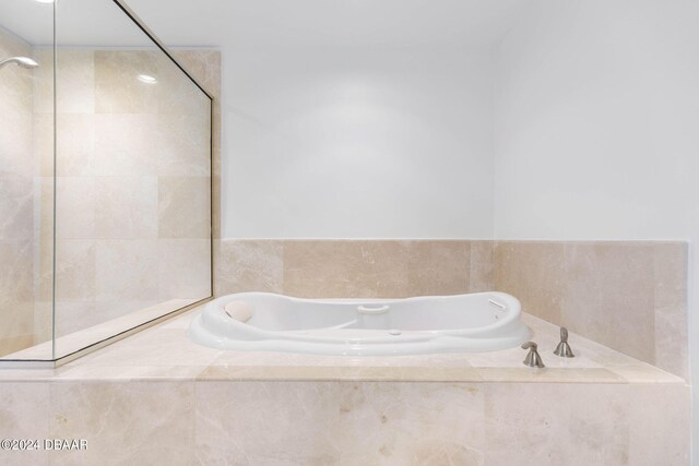 bathroom with tiled tub