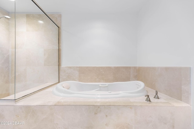 231 Riverside Dr Unit 1209-1, Daytona Beach, FL 32117 - full bathroom featuring a garden tub and tiled shower