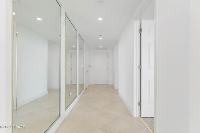 hall featuring light tile patterned flooring