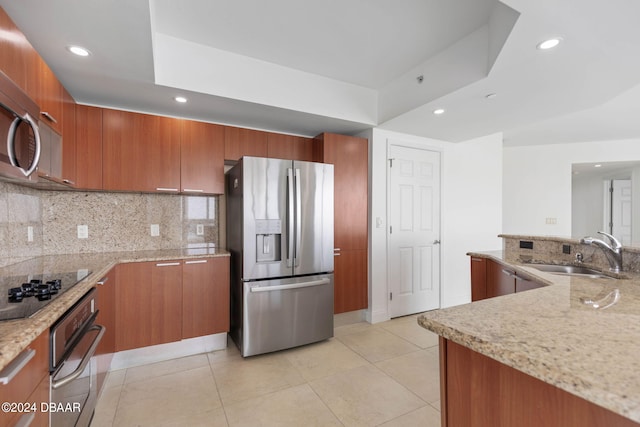 kitchen featuring light tile patterned floors, sink, backsplash, light stone countertops, and appliances with stainless steel finishes