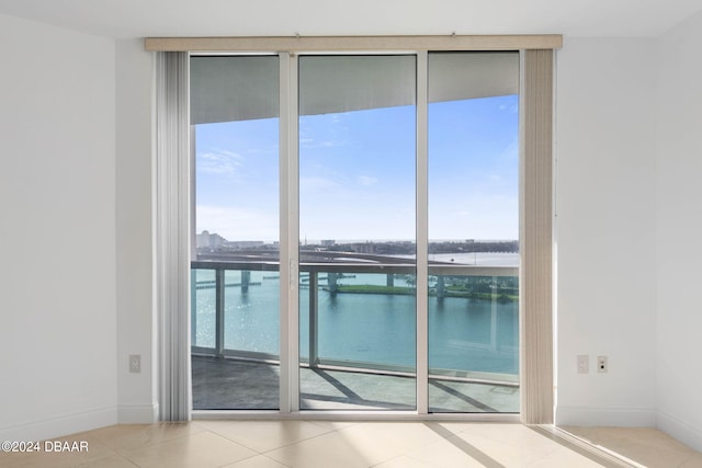 interior space featuring tile patterned floors and a water view