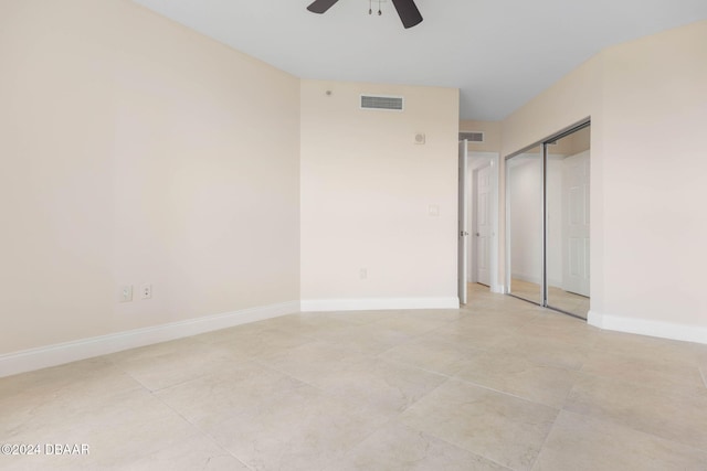 231 Riverside Dr Unit 1209-1, Daytona Beach, FL 32117 - unfurnished bedroom with ceiling fan, baseboards, light tile patterned floors, and a closet