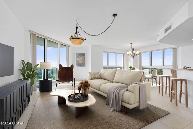 tiled living room with an inviting chandelier