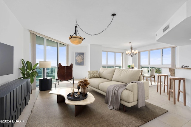 231 Riverside Dr Unit 1209-1, Daytona Beach, FL 32117 - living room featuring a chandelier and floor to ceiling windows