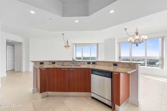 kitchen with stainless steel dishwasher, an island with sink, decorative light fixtures, and a notable chandelier