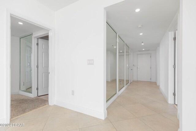 corridor featuring light tile patterned floors