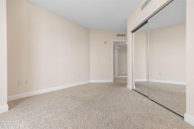 unfurnished bedroom with carpet and a closet