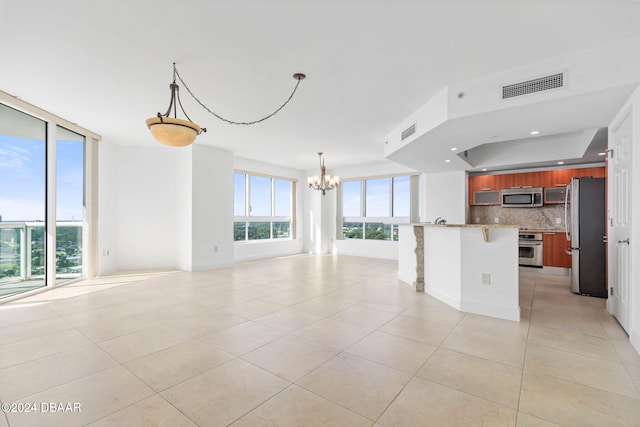 unfurnished living room with light tile patterned floors and a notable chandelier