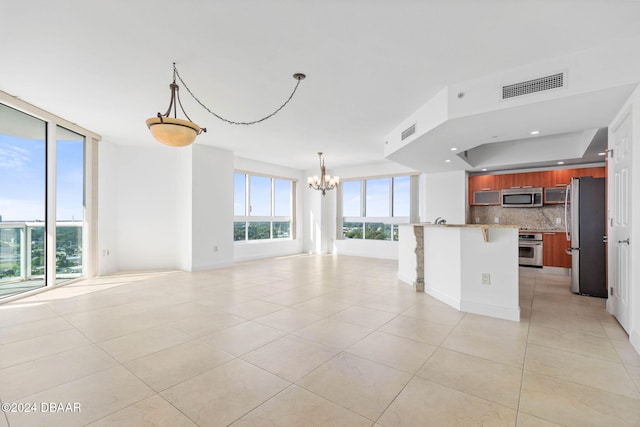 231 Riverside Dr Unit 1209-1, Daytona Beach, FL 32117 - unfurnished living room featuring light tile patterned flooring and a chandelier