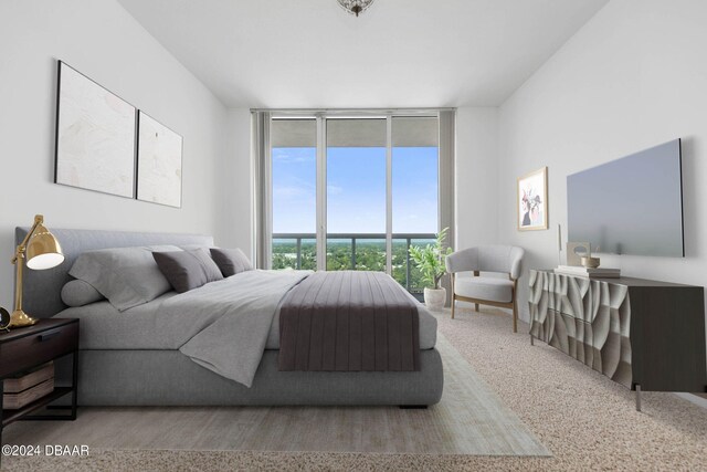 carpeted bedroom featuring expansive windows