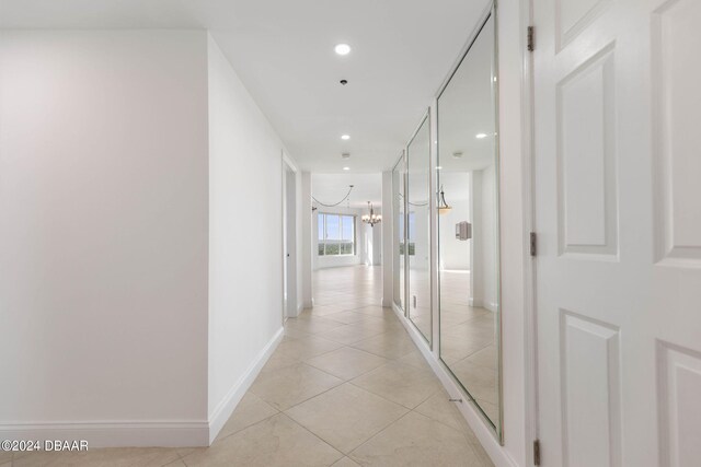 231 Riverside Dr Unit 1209-1, Daytona Beach, FL 32117 - hallway with a chandelier, light tile patterned floors, recessed lighting, and baseboards