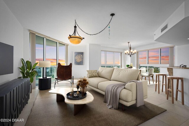 231 Riverside Dr Unit 1209-1, Daytona Beach, FL 32117 - living room with a chandelier and expansive windows