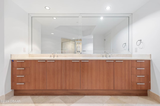 bathroom with an enclosed shower, vanity, and tile patterned floors