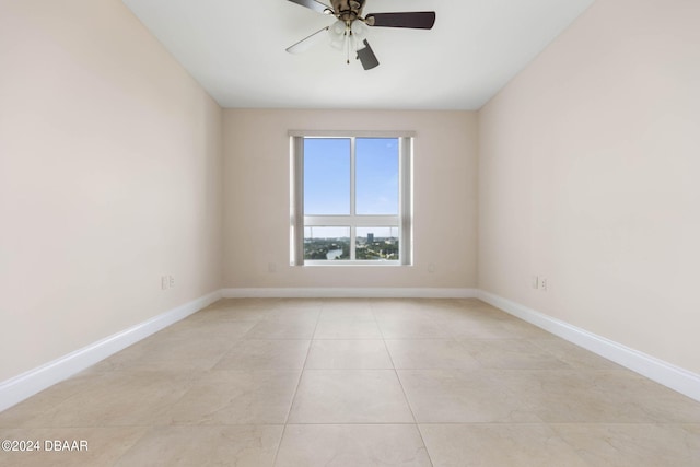 unfurnished room with light tile patterned flooring and ceiling fan