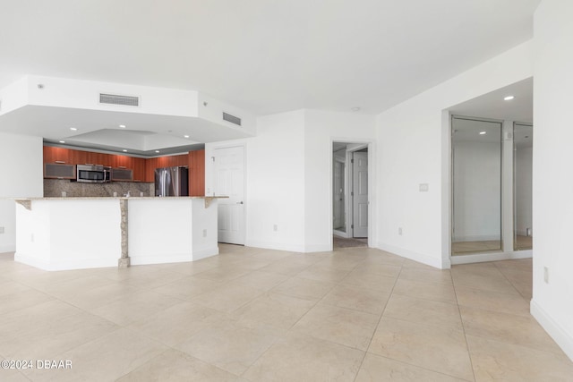 unfurnished living room featuring light tile patterned floors