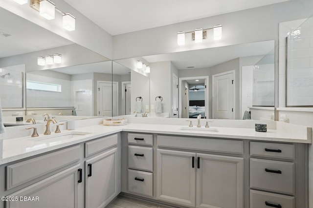 70 Esperanto Dr, Palm Coast, FL 32164 - bathroom with double vanity, a tile shower, connected bathroom, and ceiling fan