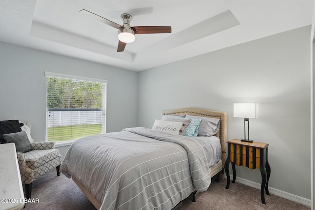 70 Esperanto Dr, Palm Coast, FL 32164 - carpeted bedroom with a tray ceiling and a ceiling fan