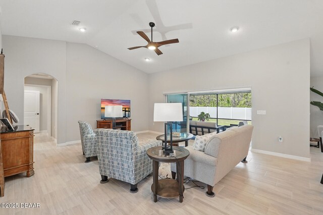 70 Esperanto Dr, Palm Coast, FL 32164 - living room featuring arched walkways, a ceiling fan, lofted ceiling, and light wood-style floors