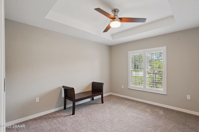 70 Esperanto Dr, Palm Coast, FL 32164 - spare room with a tray ceiling, light carpet, and a ceiling fan