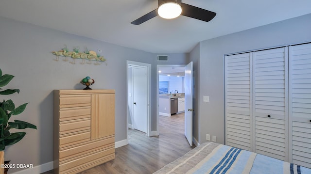 4601 S Atlantic Ave Unit 702, Ponce Inlet, FL 32127 - bedroom with visible vents, a ceiling fan, wood finished floors, baseboards, and a sink