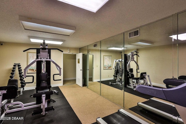 4601 S Atlantic Ave Unit 702, Ponce Inlet, FL 32127 - workout area with baseboards, a textured ceiling, and visible vents