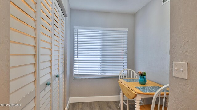4601 S Atlantic Ave Unit 702, Ponce Inlet, FL 32127 - dining area with baseboards, wood finished floors, and visible vents
