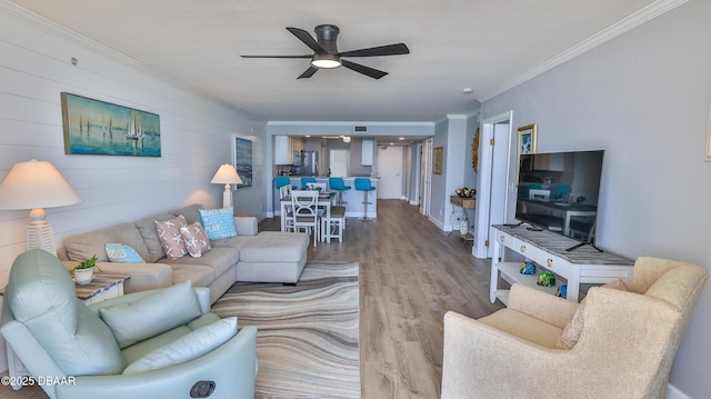 4601 S Atlantic Ave Unit 702, Ponce Inlet, FL 32127 - living area featuring a ceiling fan, ornamental molding, and wood finished floors