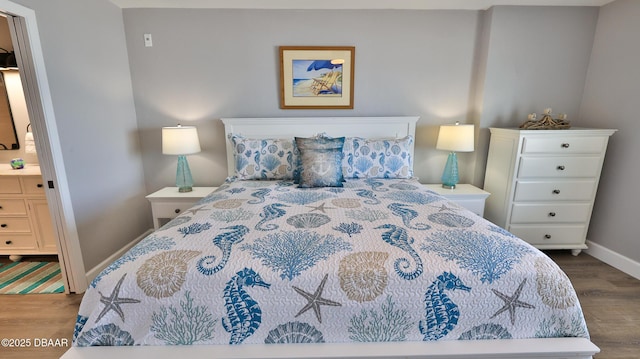 4601 S Atlantic Ave Unit 702, Ponce Inlet, FL 32127 - bedroom featuring baseboards, ensuite bathroom, and wood finished floors