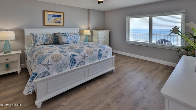 4601 S Atlantic Ave Unit 702, Ponce Inlet, FL 32127 - bedroom featuring baseboards and wood finished floors