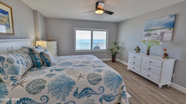 4601 S Atlantic Ave Unit 702, Ponce Inlet, FL 32127 - bedroom with light wood-type flooring, baseboards, and ceiling fan