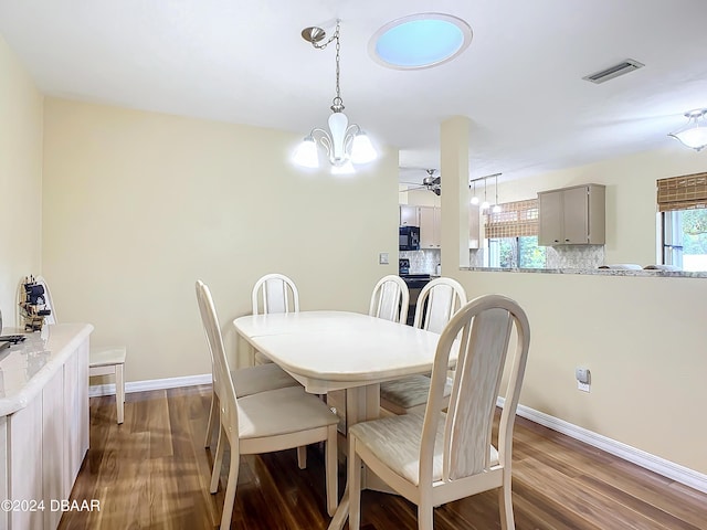 111 Grey Branch Rd, Port Orange, FL 32128 - dining space with dark wood finished floors, ceiling fan, and a chandelier