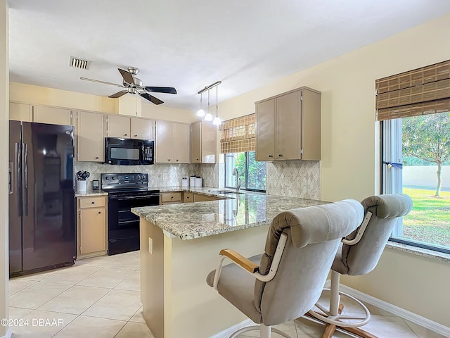 111 Grey Branch Rd, Port Orange, FL 32128 - kitchen featuring black appliances, a peninsula, tasteful backsplash, ceiling fan, and light tile patterned floors