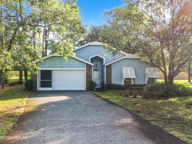 111 Grey Branch Rd, Port Orange, FL 32128 - ranch-style house with asphalt driveway, a garage, and brick siding