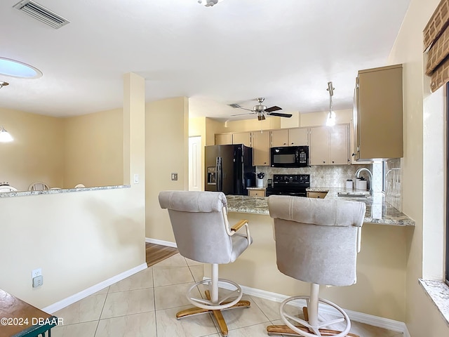 111 Grey Branch Rd, Port Orange, FL 32128 - kitchen featuring black appliances, backsplash, a ceiling fan, a peninsula, and a breakfast bar