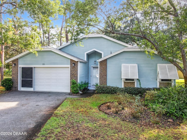 111 Grey Branch Rd, Port Orange, FL 32128 - view of front of house featuring brick siding, a garage, and driveway